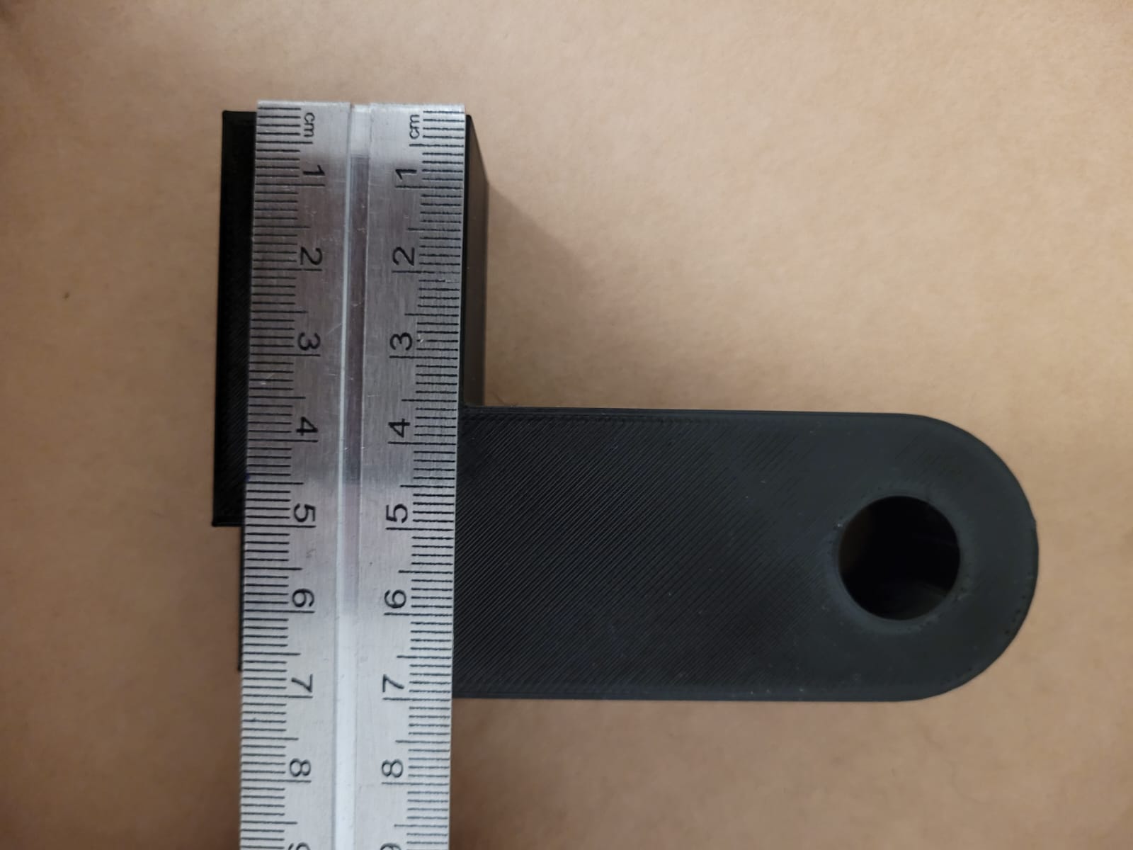 Figure 3 - Part brought by the client comparing measurements with a steel scale (detail b)